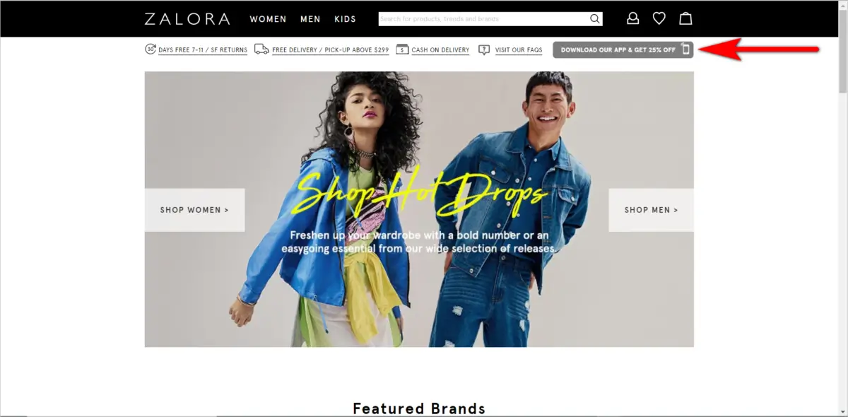 ZALORA's homepage banner featuring two models in trendy denim looks, with a call-to-action for the latest 'Shop Hot Drops'. An arrow points to an incentive offering a 25% discount for downloading the ZALORA mobile app, encouraging fashionable online shopping